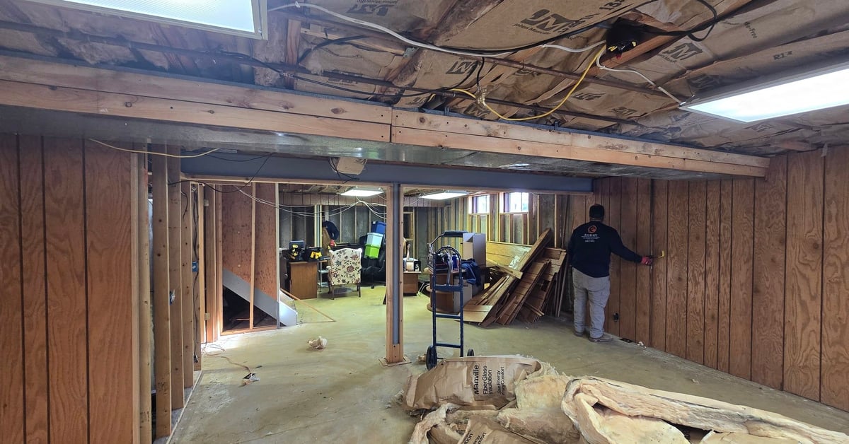 Basement remodel in progress, showing framing and insulation installation.