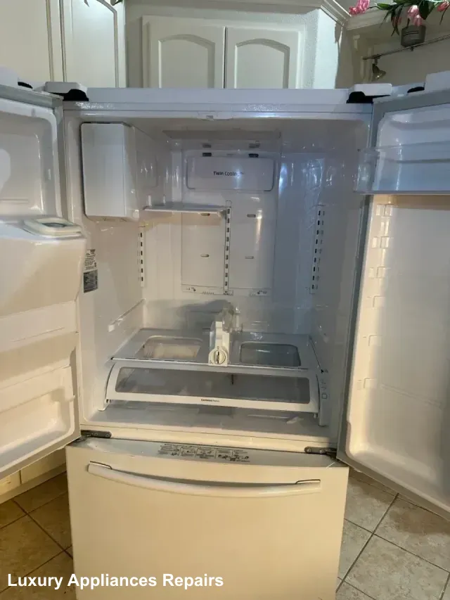 Interior of a white French door refrigerator with doors open after a repair service.