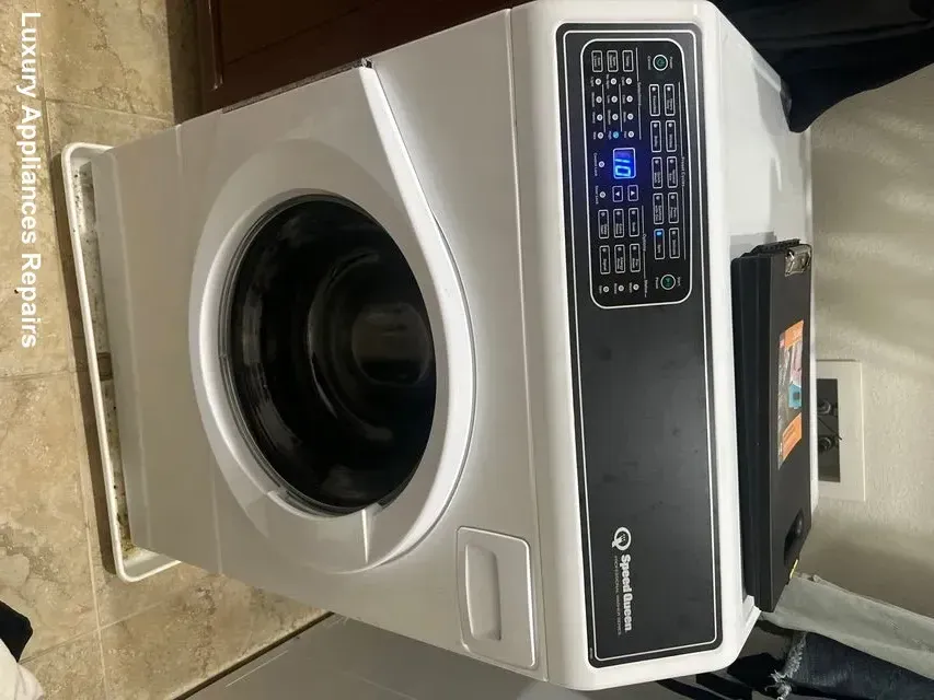 A white Speed Queen front-load washing machine during a repair service by Luxury Appliances Repairs.