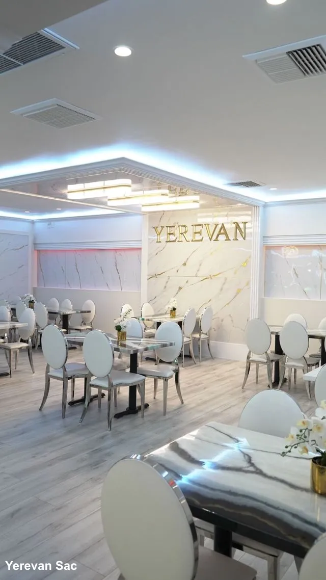 Elegant Interior Seating at Yerevan Sac Restaurant. A view of Yerevan Sac's main dining area, showcasing comfortable seating arrangements, stylish decor, and warm lighting, creating an inviting atmosphere for guests.